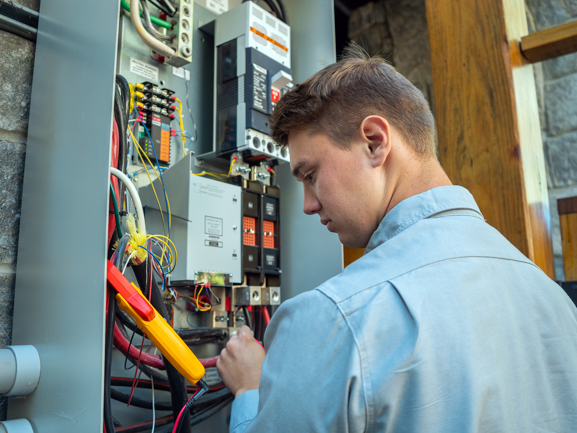 A Fountain Electric technician checking on an exterior panel.