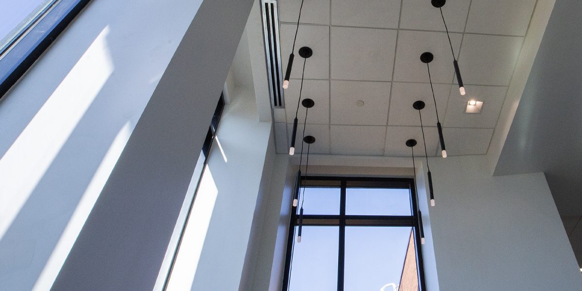Vertical view of architectural pendant lighting and high-ceiling electrical installation by Fountain Electric.
