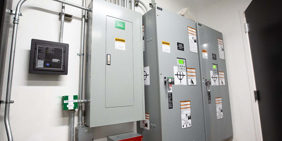 Commercial electrical room installation featuring ASCO transfer switches and Kohler power controls by Fountain Electric.